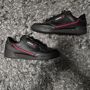 Adidas Continental 80, specifically the "Core Black" or "Black Scarlet" edition.